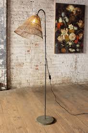 Bohemian Rattan And Metal Floor Lamp Woodwaves A bright boho patio with wooden and metal lanterns, rattan lamps on the floor, colorful and printed textiles, rugs and pillows.