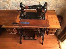 A singer red eye treadle machine in a sewing table sold for $1,800 in 2020. Sewing Machines Antique Sewing Machine Cabinet