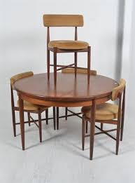 A Vintage G Plan Round Extending Dining Table With Four Original Teak G Plan Dining Chairs In Ori Choose an elegant teak extending table with padded upholstery chairs that feature ladder backrests.