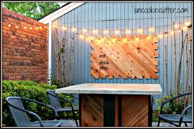 In case you hadn't noticed, outdoor spaces have been on my mind lately — particularly how to create stylish outdoor spaces for less. Outdoor Wall Art Fun Easy Sign For The Courtyard Uncookie Cutter