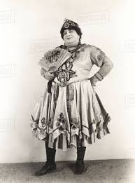 The 1920s opened with an explosion of color, the wailing sounds and fast rhythms of jazz, and the energetic dancing that went with it. Man With Fan Dressed In Women S Clothing 1920s Stock Photo Dissolve