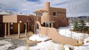 Others are northern new mexico style, with pitched tin roofs and stucco exteriors. Ad Visits Cher S Adobe Retreat In Aspen Architectural Digest