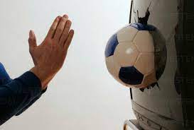 Man worshipping soccer ball stock photo