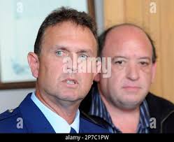 Police superintendent Gary Knowles speaks as Pike River Mine Ltd. Chief  Executive Peter Whittall, right, listens during a media briefing in  Greymouth, New Zealand, Sunday, Nov. 21, 2010. Anguished relatives of 29  workers missing after an explosion at ...