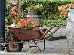 34 Way To Use That Old Wheelbarrow As A Planter Ideas And Pictures Garden Containers Wheelbarrow Planter Wheelbarrow