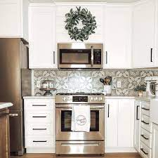 Dark wood cabinets above our kitchen sink and stove were also one of the first things we tore down from the original kitchen. One Compromise Tanner And I Made When We Were Working On The Kitchen Was Doing A Microwave Above The Stove Inste In 2020 Simple Kitchen Design Stove Decor Kitchen Redo