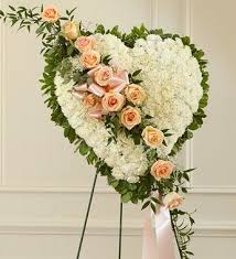 Solid Heart Standing Spray Accented With A Slash Of Peach Roses Symbol Of Love Sympa Funeral Floral Arrangements Funeral Flower Arrangements Funeral Flowers
