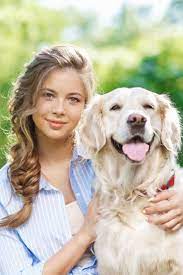 young woman sitting on the grass with golden retriever dog in the summer park goldenretriever golden retriever dogs golden retriever retriever