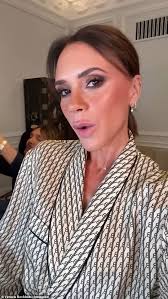 Harper Beckham, 13, is glued to her phone as she steps out in Paris holding  £1,850 Goyard tote bag while stylish mother Victoria tries to keep low-key 