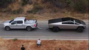 While heavier than aluminum, the stainless steel doesn't need to be painted and adds to the unique look of the truck. Tesla Cybertruck Tug Of War With Ford F 150 Shown In Better Video