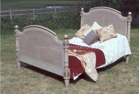 Framed in exotic bamboo, the platform bed's upholstered headboard in soft woven fabric brings a sense of refined luxury to the bedroom. Elise French Rattan Bed