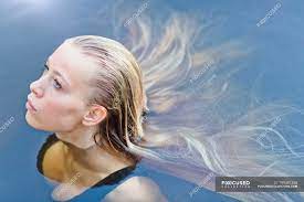Maybe you would like to learn more about one of these? Portrait Beautiful Blonde Teenage Girl With Long Hair Floating In Swimming Pool Sensuality Posing Stock Photo 199381358