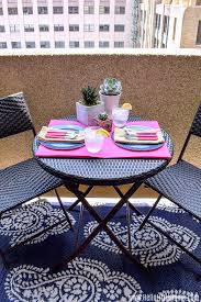 A small outdoor rug will add a pop of color and style to your small outdoor space. How To Decorate A Small Patio On A Budget Hello Little Home