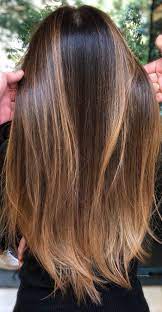Gangster raising gun and looking away on dark background. Best Hair Color Inspiration For You To Try This Summer Brunette Looks
