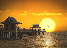 sunset at naples pier at naples beach florida after the rain