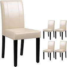 White lacquer cabinets, stainless steel appliances, and minimalist designs would work well with white leathered kitchen chairs. Amazon Com Victone Dining Chairs Pu Leather Modern Urban Style Home Kitchen Armless Side Chair With Solid Wood Legs Living Room Chairs Set Of 4 Beige White Chairs