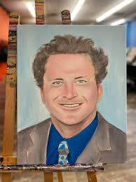 Justin Q YoungJr the owner of Paint and Sip put paint to canvas. This  painting will be presented to the family of Coach Glenn Jones. Paint and  Sip experience, conveniently located on