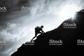 Black And White Image Of Man Climbing Up A Mountain Stock Images Free Man Images Image