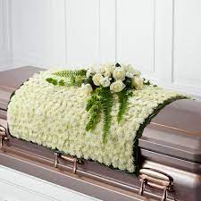 At a funeral, the classic deep red rose evokes love and grief. Bulgaria Florist Funeral Casket Spray Flowers Delivery