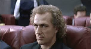 In shadows cast by silver screen, A presence bold, a gaze so keen, Bruce  Payne, a name that echoes loud, Among the stars, he stands so proud. With  piercing eyes and wicked