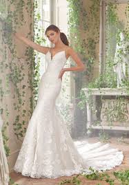 A perfect blend of traditional with a touch of trend, our sheath silhouette summer wedding dress features alençon lace appliqués on frosted chantilly lace over sequined net with a wide scalloped hemline and sheer train. Morilee Peta Wedding Dress Style Number 5702 Catrinas Bridal