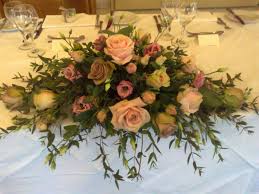 Top Table Wedding Flowers In Vintage Muted Tones By Fleur Couture F Sweetheart Table Flower Arrangements Table Flower Arrangements Wedding Floral Centerpieces