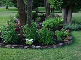 Depending on the chosen flowers, the tree mulch can benefit both flowers and the tree. 18 Genius Flower Beds Around Trees You Need To See The Art In Life Large Backyard Landscaping Landscaping Around Trees Landscaping Trees