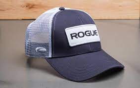 Rogue Patch Trucker Hat Navy Shown Sitting On A Table Trucker Hat Mens Trucker Hat Rogues