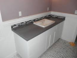 Photo of a large traditional bathroom in london with white tile, beige walls, dark hardwood floors, brown floor, a double shower, subway tile and a console sink. Grey Ceasarstone Countertop With Carrera Marble Floor Stocker Tile
