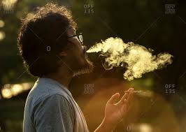 blowing smoke stock photos - OFFSET