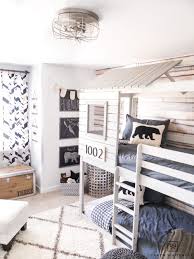 Bringing together antlers, glass, and reclaimed wood adds a modern touch to a mountain master bedroom. Modern Adventure Boys Room Taryn Whiteaker