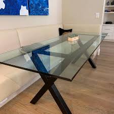 Round glass top of this cocktail table sits lightly on a geometric base with wooden legs splayed as spider's legs (though there are six of them, not eight). Best Metal Table Bases For Glass Tops Made To Order