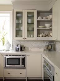 Ivory Kitchen Design With Cream Glass Front Cabinets Open Shelves Painted A Warm Gray Pai Corner Kitchen Cabinet Kitchen Cabinet Design Corner Storage Cabinet
