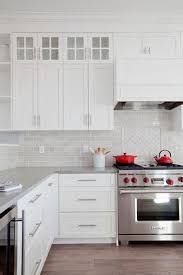 Pops Of Red Bring Life To This Gorgeous White And Gray Kitchen Featuring A Wolf Range Topped Wit Kitchen Renovation New Kitchen Cabinets Kitchen Cabinet Design