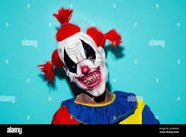 scary evil clown with red hair ...