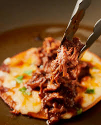 Top the beef with chopped onion and cilantro. Birria Tacos Con Consome Glebe Kitchen