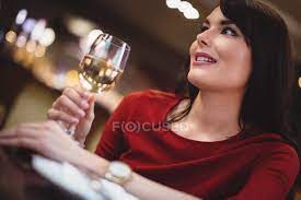 Check spelling or type a new query. Close Up Of Woman Holding Wine Glass In Restaurant Smiling Champagne Stock Photo 225286638