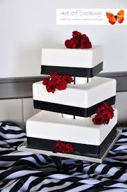 Modern Square White And Black Wedding Cake With Fresh Red Flowers In 2020 Wedding Cakes Modern Square Modern Wedding Cake Black And White Wedding Cake