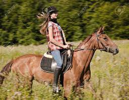 Young Cowgirl Riding A Bay Horse Stock Photo, Picture and Royalty Free  Image. Image 15366968.