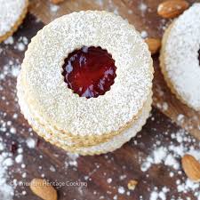 The origional austrian recipe states to roll the cookies into beaten egg whites before rolling in the nuts. Traditional Raspberry Linzer Cookies Christmas Cookies