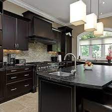 If you're looking for a sleek, modern look, opt for a dark gray or black quartz countertop to set off a white backsplash and white cabinets. Black Kitchen Cabinets Wood Floor