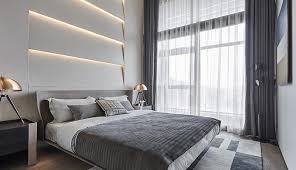 Paint one wall a bright or bold color. A Layered Accent Wall With Indirect Lighting Creates A Glow Above The Headboard In This Bedroom