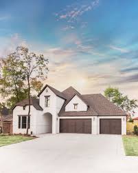 Black And White House With Wood Garage Door Traditional White Painted Brick Home With Dark Brown Garage Doors Painted Brick House White Brick Houses Painted Brick Exteriors