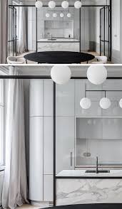 Decorations for above kitchen cabinets. A Black Framed Glass Wall Separates The Kitchen From The Dining Room In This Apartment