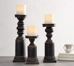 This candleholder holds tealight/votive candles, which you'll need to buy separately. Painted Carved Wood Pillar Holders Black Candle Holder Pottery Barn