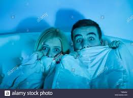 frightened couple watching a horror movie Stock Photo - Alamy