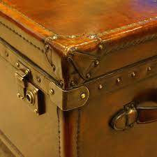 This wooden trunk features an old world map glazed and lacquered surface with genuine leather appointments for worldly charm. Leather Trunk Coffee Table Handles Hingstons Antiques Dealers