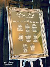 mirror wedding table plan with modern calligraphy fonts