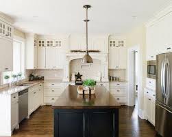 Providing a neutral backdrop, white kitchen cabinets can be left alone or dressed up with colorful art and accessories. White Cabinets Dark Island Kitchen Design Instaimage