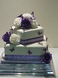 A 2 Tier Square Wedding Cake In Ivory Finished With Purple And Ivory Roses And Purple Wedding Cakes Simple Purple Butterfly Wedding Cake Simple Wedding Cake